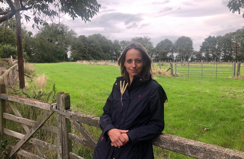 Helen leaning on farm gate