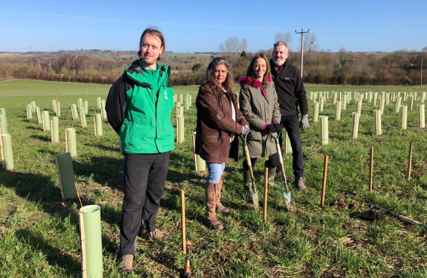 Helen planting trees at Pleasant Farm