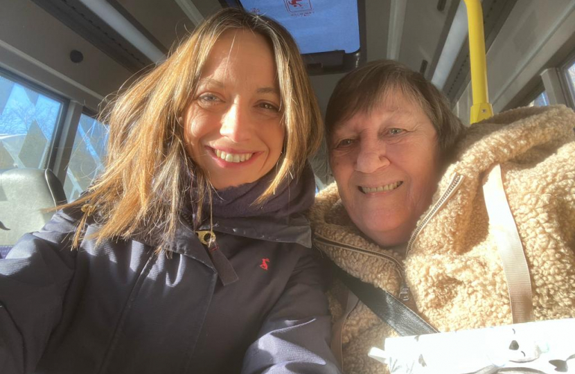 Helen with a passenger aboard the bus