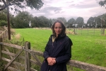 Helen leaning on farm gate