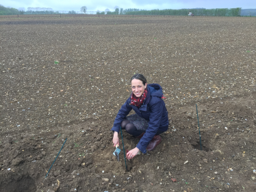 Helen planting a tree 