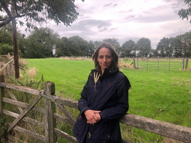 Helen leaning on farm gate