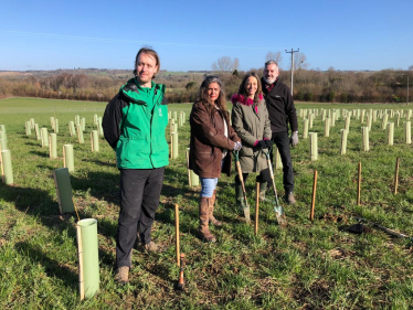 Helen planting trees at Pleasant Farm