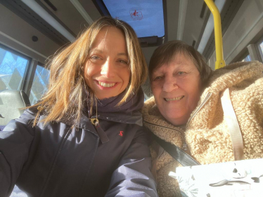 Helen with a passenger aboard the bus